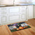 Briarwood Lane Spooky Kittens Halloween Doormat with jack-o-lantern, bats, and spooky scene on kitchen floor.