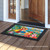 Briarwood Lane 5 O'Clock Paradise Summer Doormat with colorful parrot and floral design on wooden porch.