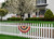 Briarwood Lane tea-stained patriotic bunting on white picket fence with American flag colors, aged USA decoration.