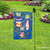 Briarwood Lane wrought iron garden flag stand holder in a decorative garden setting with flags hanger.