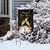 Briarwood Lane Happy New Year garden flag with champagne and colorful decorations on a snowy lawn.
