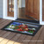 Briarwood Lane Christmas Tree Farm Pickup Doormat on a porch with a colorful barn design.
