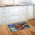Briarwood Lane Christmas Tree Farm Pickup small printed doormat on wooden floor in front cabinet.