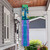 Briarwood Lane spring windsock with inspirational floral design and colorful streamers hanging from a porch.