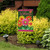 Briarwood Lane Welcome Daisies small printed garden flag with colorful springtime flowers on a lawn display.