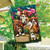 Briarwood Lane colorful spring house flag with playful dog puppies and flowers on a sunny porch.