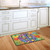 Briarwood Lane Peace Floral doormat on a kitchen floor with colorful rainbow butterfly design.