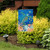 Briarwood Lane small swimming sea turtle garden flag on a yard display near sand and sun.