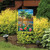 Briarwood Lane small printed garden flag with colorful beach scene and palm trees on sand shore.
