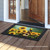 Briarwood Lane Goldfinch and Sunflowers small printed doormat on a wooden porch with colorful design.