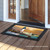 Briarwood Lane small printed doormat with colorful lighthouse on sand by ocean shore at sunset.