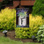 Briarwood Lane Farmhouse Monogram Letter F garden flag with colorful flowers on a small decorative yard display.