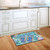 Briarwood Lane Enjoy Life Flip Flops Summer Doormat with colorful flip flops on wooden kitchen floor.