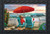Briarwood Lane Beach Life Summer Doormat with colorful beach scene and red umbrella on sand.