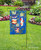 Briarwood Lane black wrought iron garden flag stand holder displayed in a yard with garden.