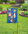 Briarwood Lane black wrought iron garden flag stand holder in a backyard garden setting.