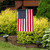 Briarwood Lane Embroidered American Garden Flag with red, white, and blue colors on a stand outdoors.