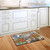 Briarwood Lane Faith and Family Farmhouse Spring doormat on a wooden kitchen floor with colorful garden design.