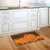 Briarwood Lane small printed decorative doormat with colorful autumn pumpkins on a kitchen floor.