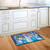 Briarwood Lane colorful spring doormat with butterflies and pansies on a kitchen floor.