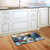 Briarwood Lane Come All Ye Faithful winter doormat on kitchen floor, snow-covered church scene indoor outdoor.
