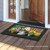 Briarwood Lane Spring Jubilee Floral doormat on a porch with colorful springtime flowers and decorative print.