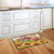 Briarwood Lane Sunflower Barn Fall Doormat on indoor kitchen floor with red barn and sunflowers.