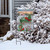 Briarwood Lane Winter Wagon Christmas Garden Flag with poinsettias and snow-covered rustic scene and pine tree.
