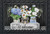 Briarwood Lane Crated Mason Jars Spring Doormat with colorful flowers and welcome sign on wooden crate.
