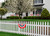 Briarwood Lane large patriotic bunting flags with applique hanging on white picket fence and house.