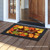 Briarwood Lane Leaf Toss Fall Doormat with colorful, turning leaves and welcome message on porch.