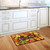 Briarwood Lane Leaf Toss Fall Doormat with colorful autumn leaves and welcome text on kitchen floor.