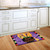 Briarwood Lane Witch Feet Halloween Doormat on a kitchen floor with a colorful halloween design.