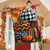 Briarwood Lane autumn house flag with colorful, printed pumpkins and stripes on a porch.