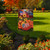 Briarwood Lane USA Pumpkins Fall Garden Flag with patriotic red, white, and blue design on porch.