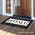 Briarwood Lane small printed decorative doormat with colorful plaid gingham and cheerful HOME design on porch.