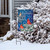 Briarwood Lane small printed garden flag with colorful cardinals, snowflakes, and inspirational quote on snowy porch.