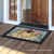 Briarwood Lane small printed doormat with white poinsettias and candle on rustic autumnal background.