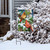 Briarwood Lane Snowy Cardinals Garden Flag with male and female cardinals on pinecones and spruce.