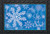 Briarwood Lane's small, printed, decorative doormat features colorful snowflakes and "Let it Snow!" on a blue background.