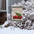 Briarwood Lane Merry Christmas garden flag with red truck, spruce, and checkered border on snowy porch.
