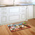 Briarwood Lane Funny Farm Summer Doormat with colorful animals and welcome text on kitchen floor.