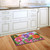 Briarwood Lane Zinnias In Bloom colorful floral spring doormat on kitchen floor beside sink area.