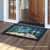 Briarwood Lane Crab Walk Summer Doormat with crab and seashells design on wooden porch floor.