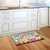 Briarwood Lane Cats Spoiled Here colorful doormat with cartoon cats on a kitchen floor display.