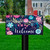 Briarwood Lane Bright Floral Spring Mailbox Cover with colorful flowers and welcome message on porch.