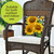 Briarwood Lane small checkered sunflowers decorative pillow on outdoor wicker chair, bright springtime summer colorful display.