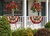 Briarwood Lane large patriotic bunting flags with applique hang on a porch with red flowers.