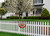 Briarwood Lane large patriotic bunting flags with applique hanging on a white picket fence outdoors.