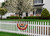 Briarwood Lane patriotic bunting on a white picket fence, aged USA american flag tea-dyed bunting.